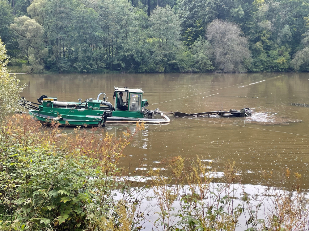 Mit dem schwimmenden Spezialgerät werden die Sedimente am Seeboden gelöst, angesaugt und durch die Leitungsrohre zum Parkplatz gepumpt.
© Gemeinde Dahlem 
